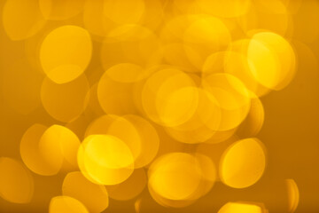 Abstract photo of bokeh on the surface water of sea or ocean at sunset time with golden light tone.