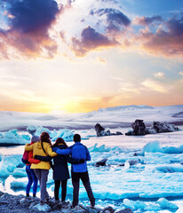 Four friends are looking at the sunset in the famous Jokulsarlon ice lagoon in Iceland. Exotic countries. Amazing places. (memories, impressions, rest, relaxation - concept) © anko_ter