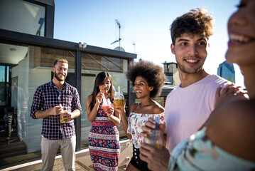 Group of friends having fun on the rooftop of a beautiful penthouse