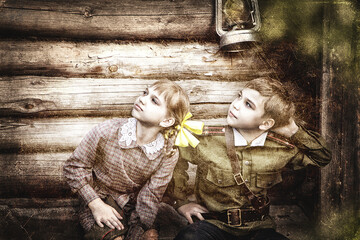 Postcard, stylized as vintage for the Victory Day. A boy in a military uniform and a girl in an old dress. The theme of May 9, Victory Day in Russia. Soft selective focus, added noise.