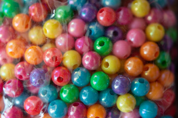 colorful plastic round beads in a box