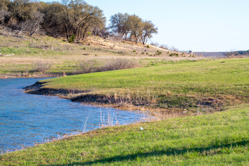 beautiful landscape of a lake  or pond with green grass in the day