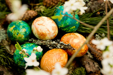 Easter. a Christian religious holiday. speckle chicken eggs in basket. tradition to variegate with various colors and various techniques. biggest spring celebration.