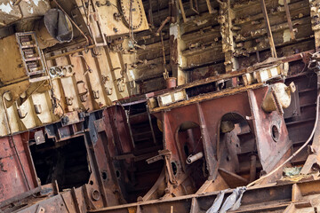 Internal parts of decommissioned marine ship that was cut and left on the shore.