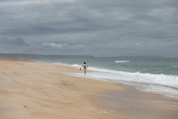 girl walking on an empty beach