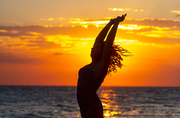 Silhouette of a yogi girl by the sea