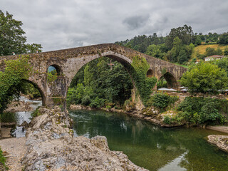 Fototapeta na wymiar peculiar stone bridge over a river