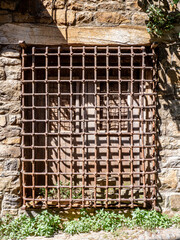 old window with a wrought iron grate