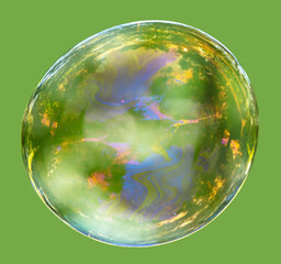 Large soap bubble on a green