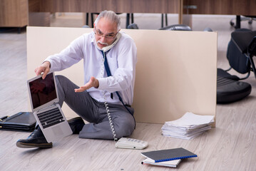 Old businessman employee in bankruptcy concept in the office