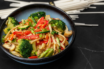 Udon noodles with vegetables: zucchini, broccoli, red bel pepper, mushrooms, carrot, spring onion...