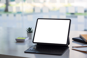 Fototapeta premium Mock up. Tablet blank white screen on desk office.