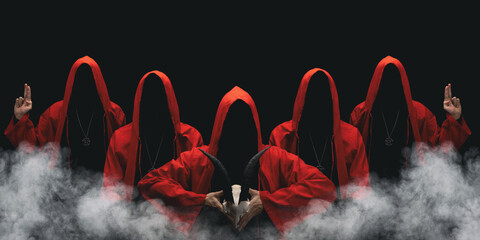 Group of mysterious figures in hooded cloaks in the dark. Leader of sectarians holds skull with horns. Horror scene with smoke. Black background. - 421821990