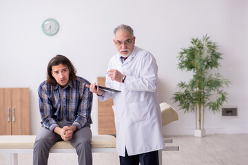 Fototapeta premium Young male patient visiting experienced doctor psychiatrist