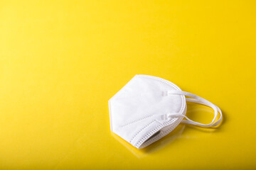close up of a Yellow isolated face mask with yellow background