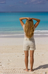 Young long-haired blonde looking into the sea