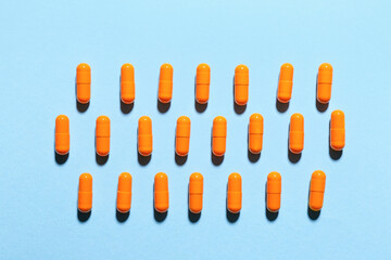 Turmeric pills on color background