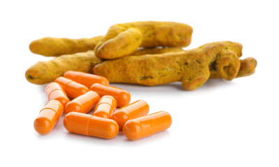 Turmeric pills and roots on white background