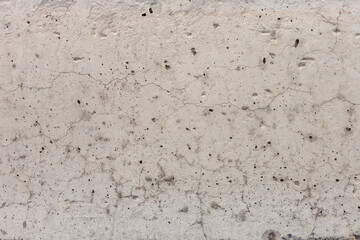 Abstract texture of light concrete with cracks and holes
