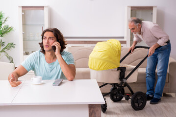 Retired grandfather looking after newborn at home