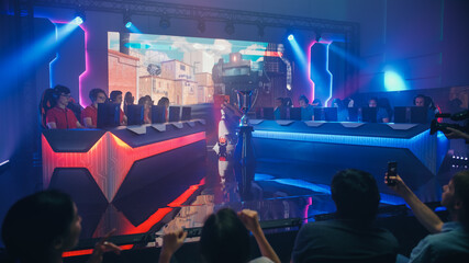 Two Esport Teams of Pro Gamers Play in FPS Shooter Video Game on a Championship Arena with Big...