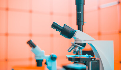 Toned photo of scientific trinocular microscope with camera in science laboratory