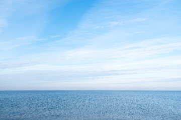 Obraz premium Calm Baltic Sea during sunny day with blue sky and some clouds near Carnikava, Latvia