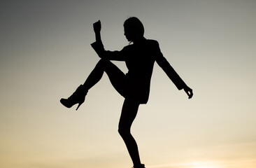 silhouette of sensual woman dancing in dusk, imagination