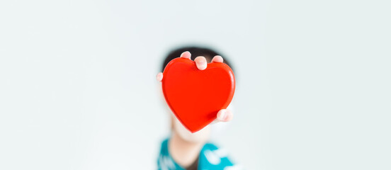 Child hands holding red heart for share Donate.Health care pediatric.family insurance.World heart day, world health day,CSR responsibility, Adoption foster kids.Worship with faith.Banner background.