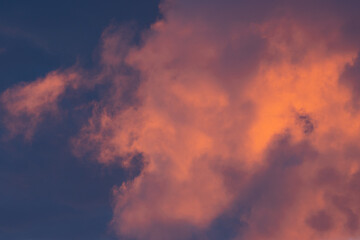 Red orange evening sky with clouds, large background image with moody evening colors