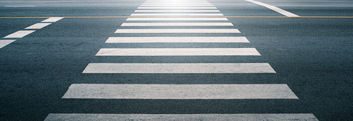 crosswalk on the road for safety when people walking cross the street, Pedestrian crossing on a repaired asphalt road, Crosswalk on the street for safety, logistic import export and transport industry