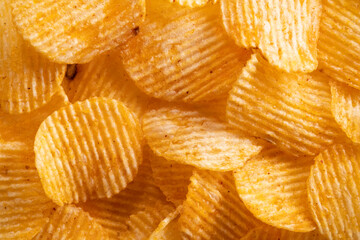 Close up crispy potato chips snack texture background