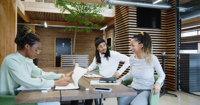 Young businesswoman meeting with
colleagues in an office
