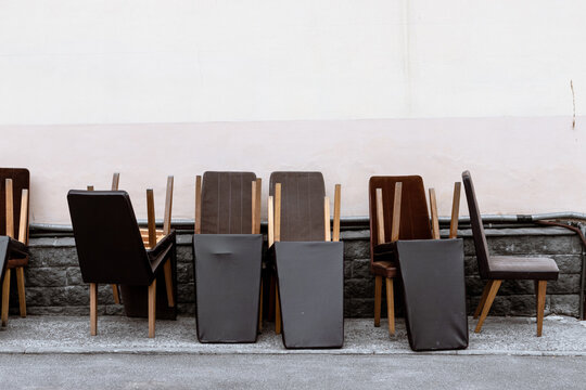 Wooden Chairs Are Stacked Along The Wall. Old Office Furniture