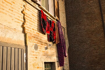 Medieval clothes hanging out the window in a medieval village (Marche, Italy, Europe)