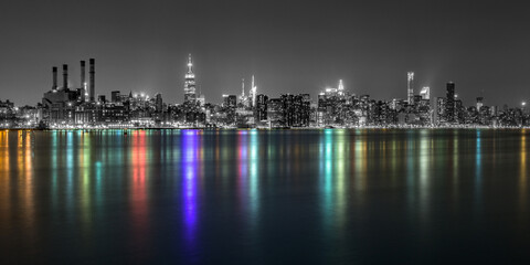 Fototapeta na wymiar East River By Illuminated Modern City Against Clear Sky At Night