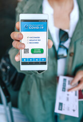 Unrecognizable woman showing covid passport on the smartphone at an airport control