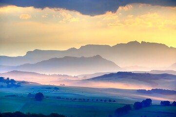 DRAMATIC DRAKENSBERG SUNSET. Setting sun refracts through cloud