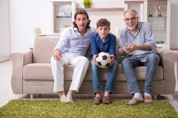 Boy and his father and his grandfother indoor