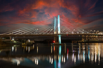 Looking south at sunset at the cable stayed Tilikum bridge over the Willamette River in Portland Oregon