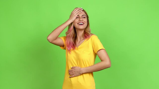 Young blonde woman keeping the arms crossed while smiling over isolated background on green screen chroma key