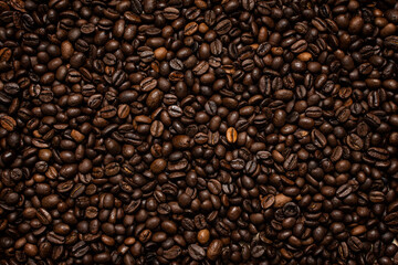 Coffee beans. Coffee beans are spread out on the surface.