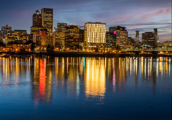 Fototapeta na wymiar Looking west at the reflection of downtown Portland Oregon in the Willamette River at sunset