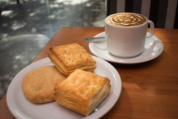 cup of coffee with cookies