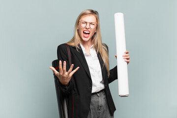 young architect woman looking angry, annoyed and frustrated screaming wtf or what’s wrong with you