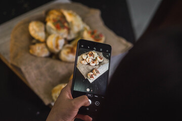 close up of a person holding a tray with a cake