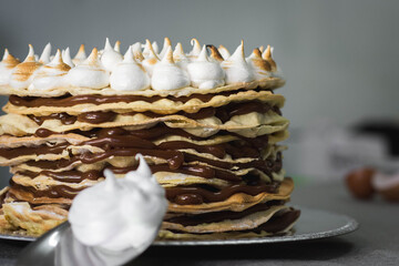 spoon with cream and meringue cake