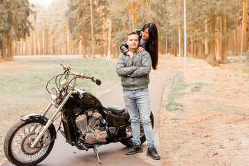 Fototapeta premium guy with a girl in the park on a motorcycle