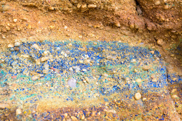 Malachite and azurite mineral vein in a sandstone terrain in a mine. Blue, green and reddish terrain