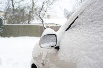 Car mirror snow capped. Outside horizontal winter-time image